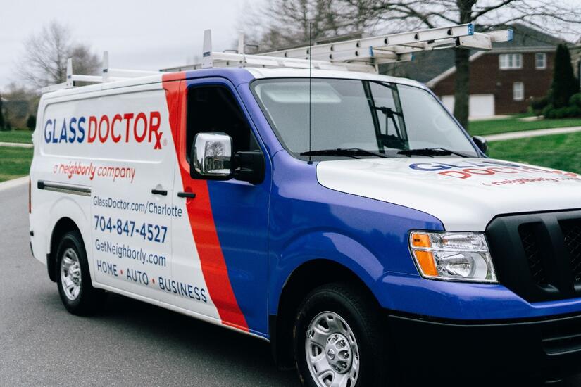 White, red and blue van with the words Glass Doctor written on it